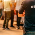 Security guard at live festivale event standing in front of the crowd